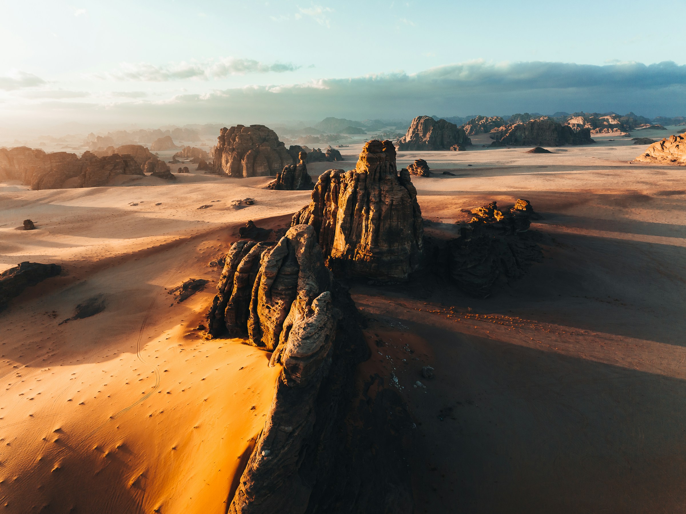 Red sand desert landscape with sandstone rock formations
